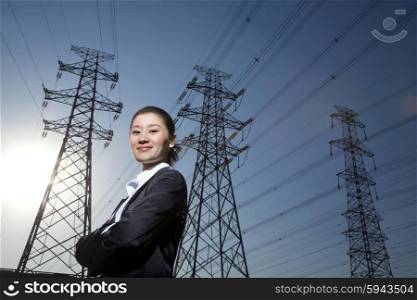 Businesswoman in front of power lines