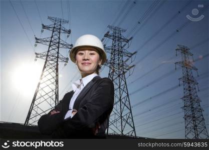 Businesswoman in front of power lines