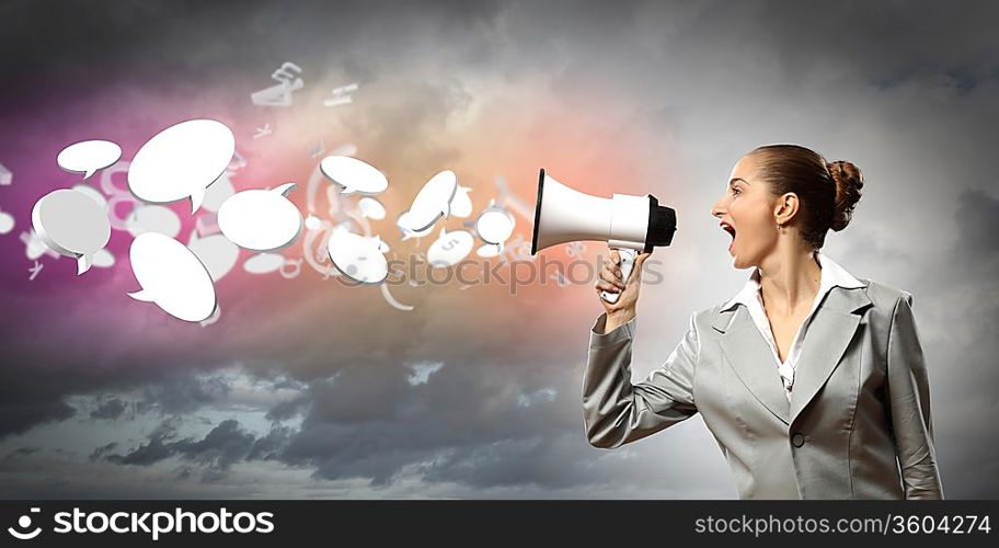 businesswoman in grey suit screaming into megaphone