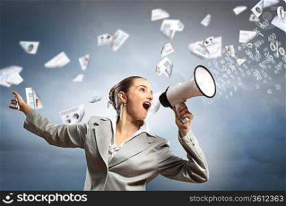 businesswoman in grey suit screaming into megaphone