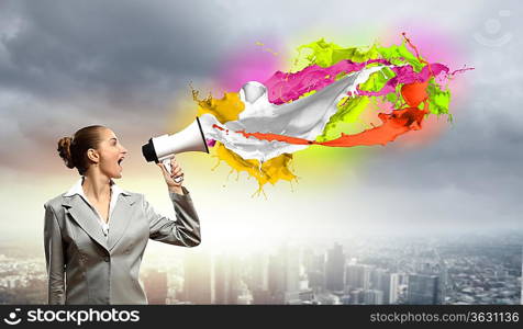 businesswoman in grey suit screaming into megaphone