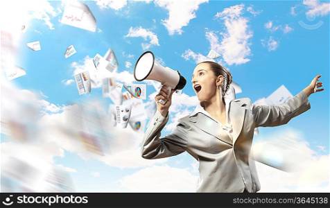 businesswoman in grey suit screaming into megaphone
