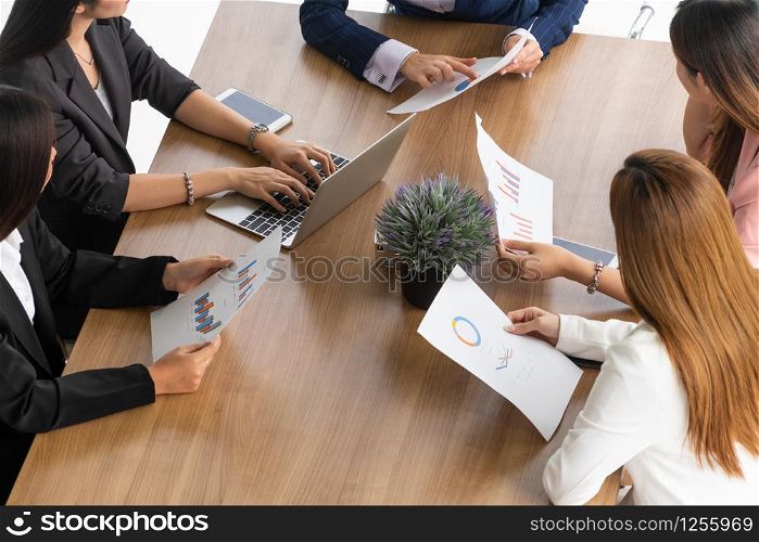 Businesswoman in group meeting discussion with other businesswomen colleagues in modern workplace office with laptop computer and documents on table. People corporate business working team concept.