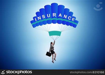Businesswoman in insurance concept on parachute