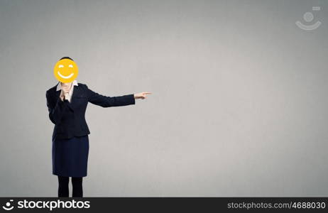 Businesswoman in mask. Unrecognizable businesswoman hiding her face behind mask and showing direction