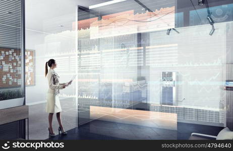 Businesswoman in modern office interior. Young successful businesswoman thinking about future of her company