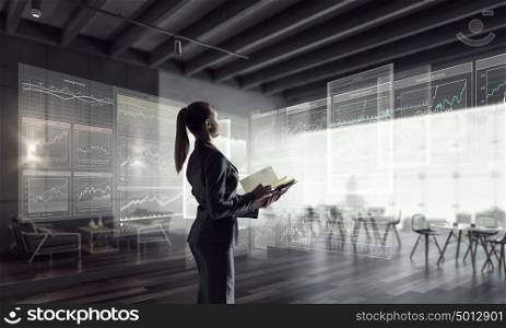 Businesswoman in modern office interior. Young successful businesswoman thinking about future of her company