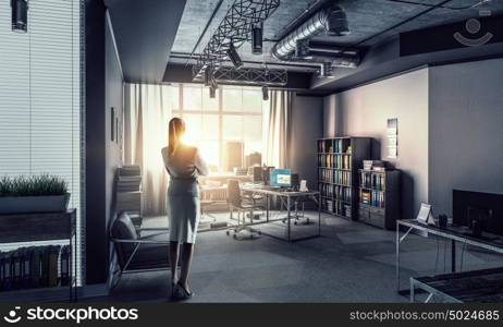 Businesswoman in modern office interior. Young successful businesswoman thinking about future of her company