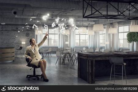 Businesswoman in office chair. Young businesswoman sitting in chair and reaching hand