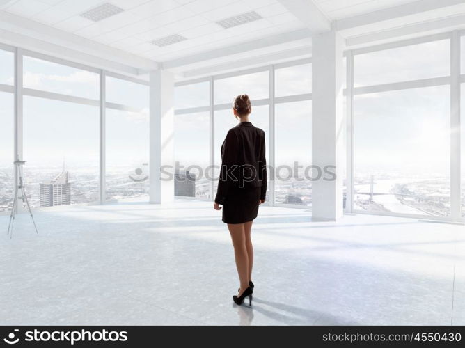 Businesswoman in office mixed media. Young successful businesswoman in white office interior