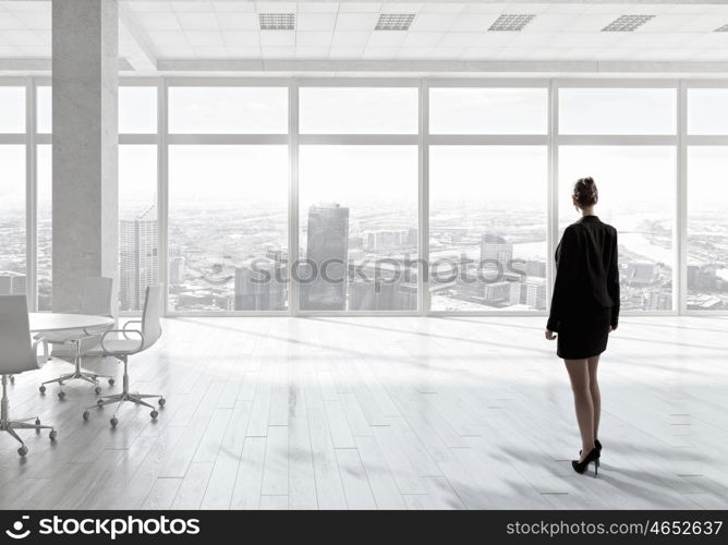 Businesswoman in office mixed media. Young successful businesswoman in white office interior