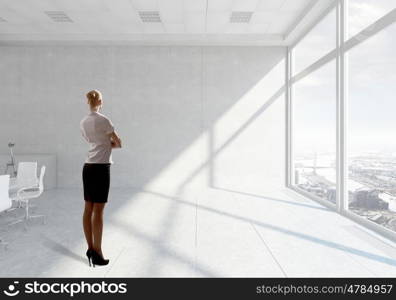 Businesswoman in office mixed media. Young successful businesswoman in white office interior