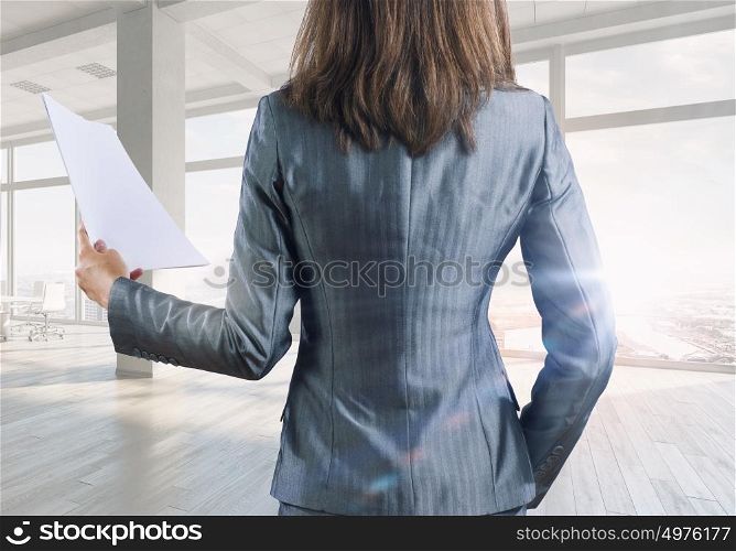 Businesswoman in office mixed media. Young successful businesswoman in white office interior close view