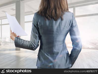 Businesswoman in office mixed media. Young successful businesswoman in white office interior close view