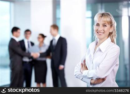 Businesswoman in office on the background of serving staff