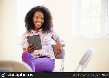 Businesswoman In Office Using Digital Tablet