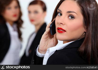 Businesswoman in red lipstick using a cellphone