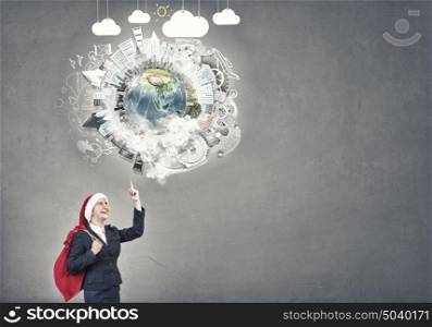 Businesswoman in Santa hat. Santa woman running with red gift bag on back. Elements of this image are furnished by NASA