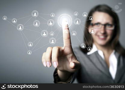 Businesswoman in suit pressing social media icon