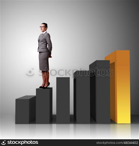 Businesswoman in suit standing near stairs going up