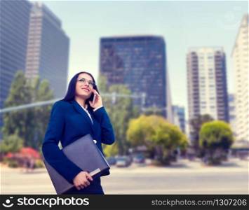 Businesswoman in suit talks by mobile phone outdoor, business center on background. Successful female businessperson. Businesswoman in suit talks by phone outdoor