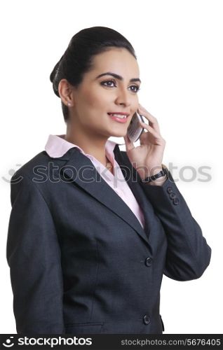Businesswoman in suit using mobile phone over white background