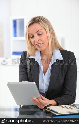 Businesswoman in the office with electronic tablet