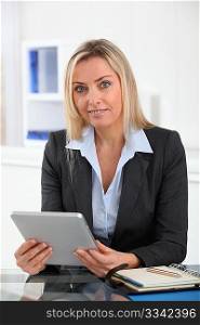 Businesswoman in the office with electronic tablet