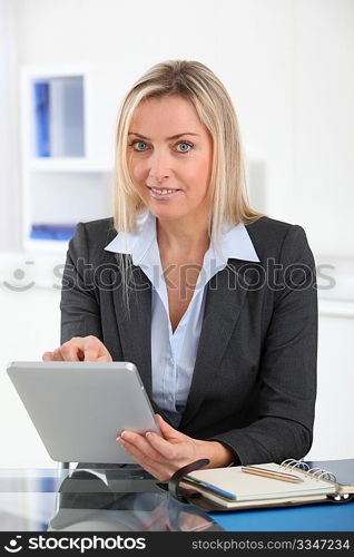 Businesswoman in the office with electronic tablet