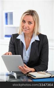 Businesswoman in the office with electronic tablet
