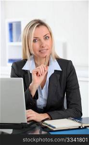 Businesswoman in the office with laptop computer
