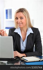 Businesswoman in the office with laptop computer