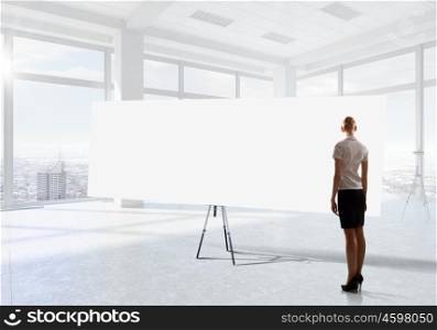 Businesswoman in top floor office. Elegant businesswoman in modern office interior against window panoramic view looking at blank banner