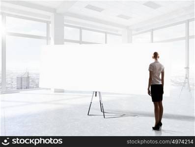 Businesswoman in top floor office. Elegant businesswoman in modern office interior against window panoramic view looking at blank banner