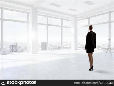 Businesswoman in top floor office. Elegant businesswoman in modern office interior against window panoramic view