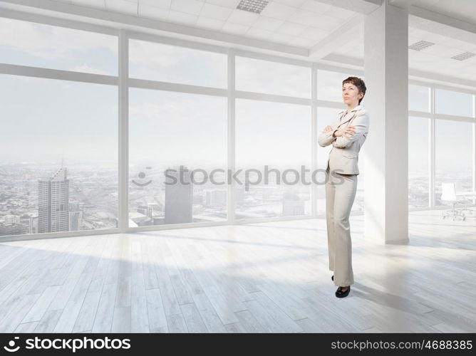 Businesswoman in top floor office. Elegant businesswoman in modern office interior against window panoramic view