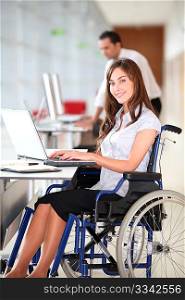 Businesswoman in wheelchair working in the office