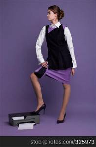 Businesswoman in working suit standing with her feet on printer in studio with purple background
