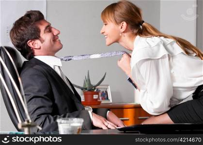 businesswoman is seducing her boss at office