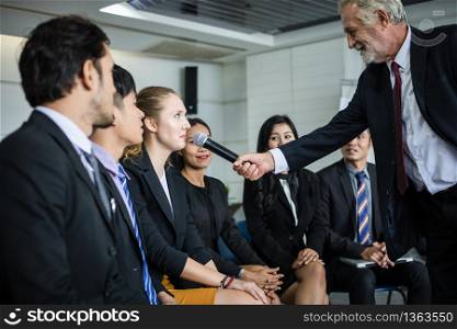 businesswoman is speaking with microphone in training for Opinion with Meeting Leader in Conference Room