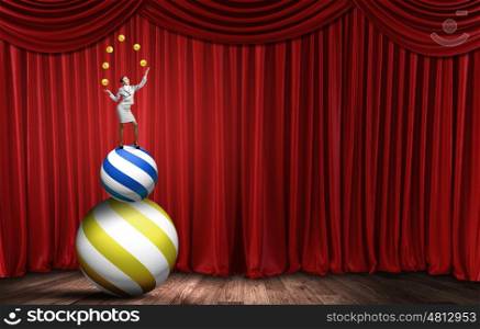 Businesswoman juggling with balls. Young businesswoman standing on ball juggling with balls