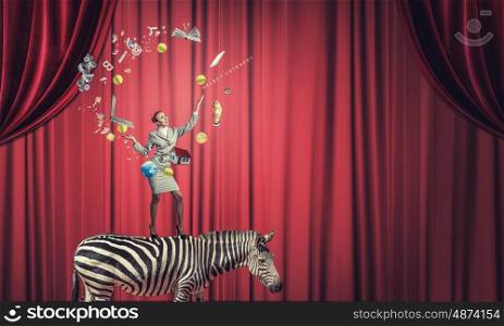 Businesswoman juggling with balls. Young businesswoman standing on zebra and juggling with balls