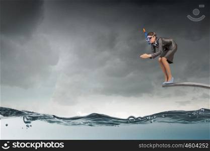 Businesswoman jumping in water. Businesswoman in mask jumping in water from springboard