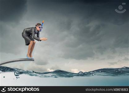 Businesswoman jumping in water. Businesswoman in mask jumping in water from springboard