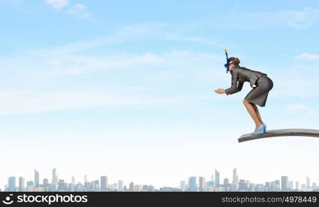 Businesswoman jumping in water. Businesswoman in mask jumping in water from springboard