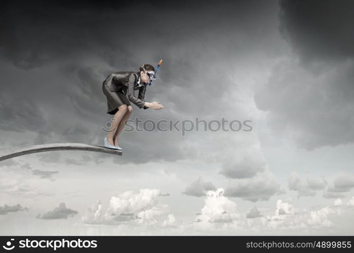 Businesswoman jumping in water. Businesswoman in suit and mask jumping from springboard