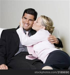 Businesswoman kissing a businessman