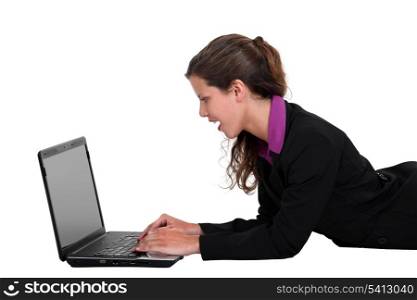 Businesswoman laying down with laptop