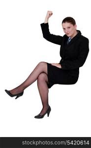 businesswoman lifting arm to show strength