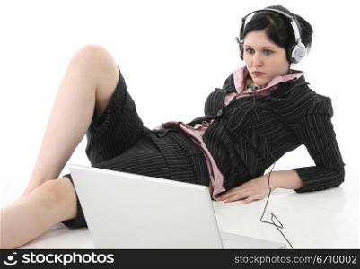 Businesswoman listening to music in front of a laptop